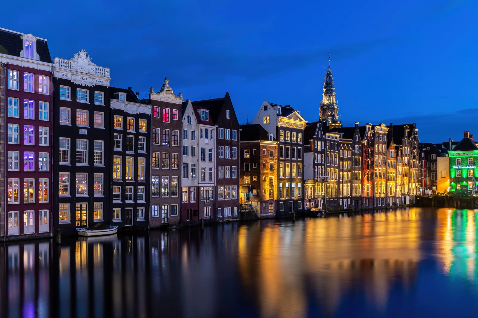 The canal houses along the Damrak in Amsterdam, the Netherlands.